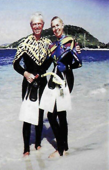 Morton and Alese Pechter in diving suits on a beach