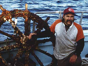 John Moyer with a recovered ship wheel
