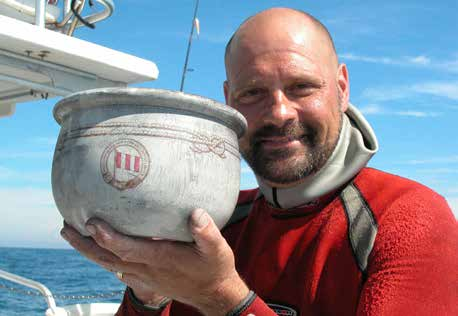 Richard Kohler holding an artifact recovered from a shipwreck